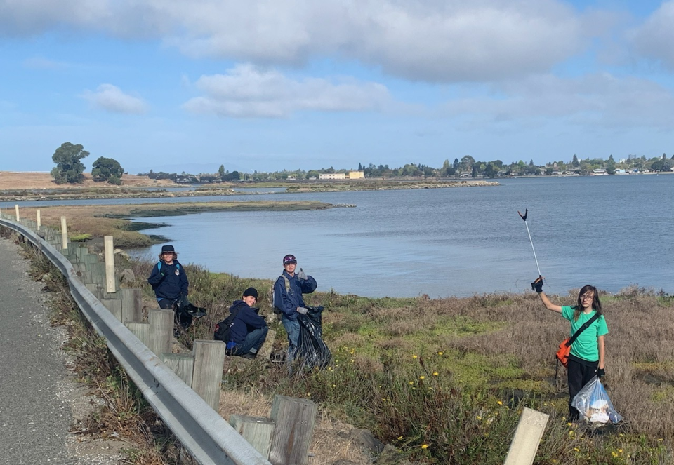 Scouts picking up trash on the shore line