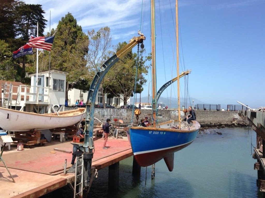 Boat suspended on davits above San Francisco Sea Scout base harbor